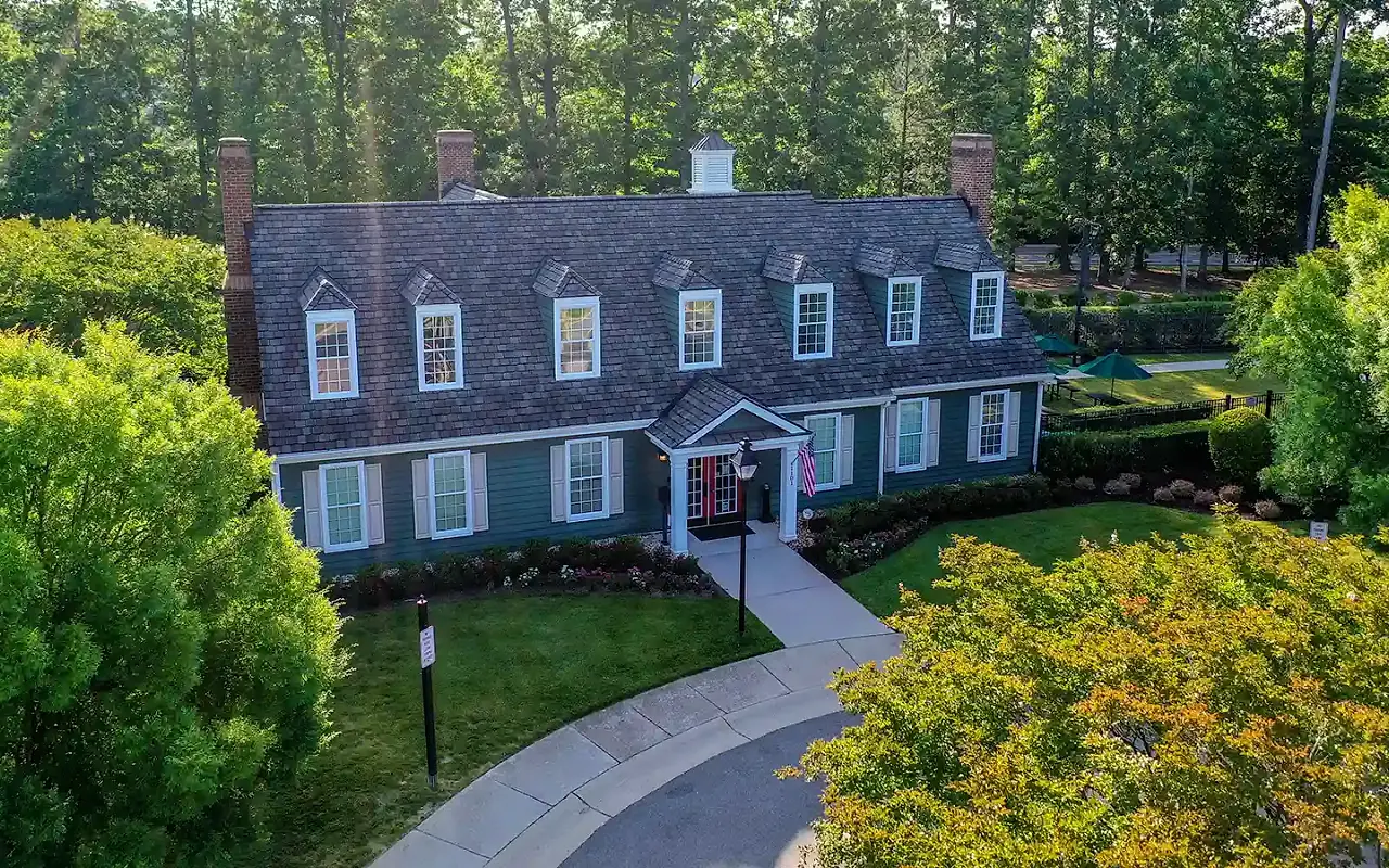 The Charter Colony clubhouse framed by mature trees and landscaped grounds
