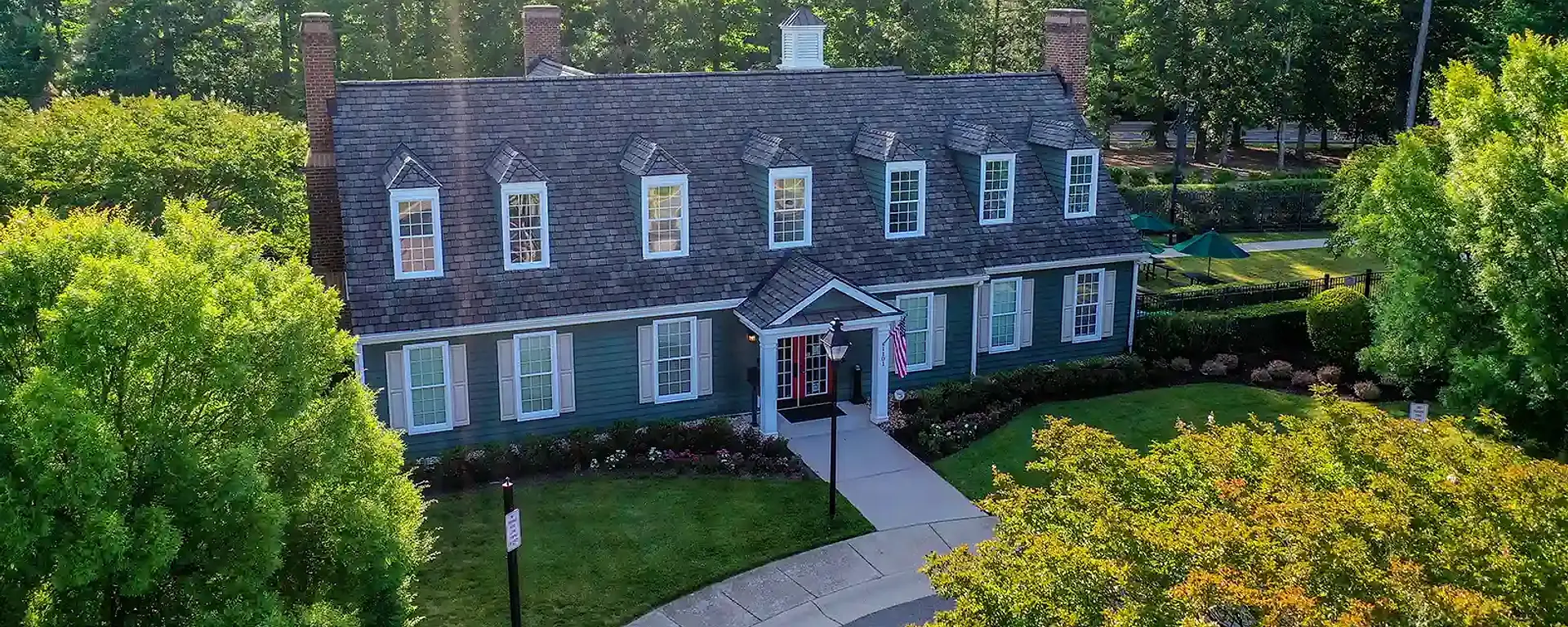 The Charter Colony clubhouse framed by mature trees and landscaped grounds