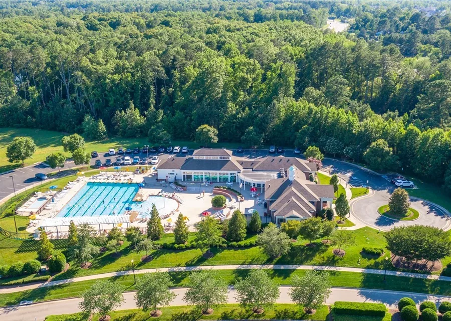 Aerial view of the Foxcreek clubhouse and swimming pool surrounded by woodland in Moseley, Virginia