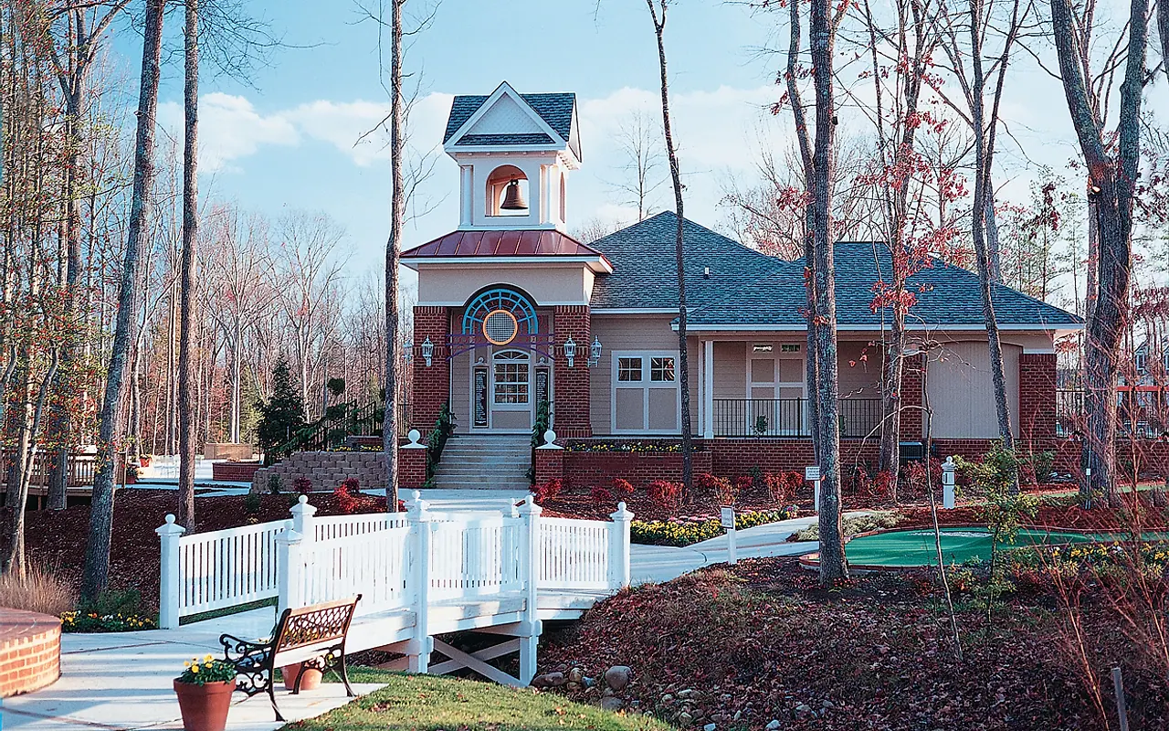 The Hampton Park residents' club, bell tower, bridge, and landscaped grounds