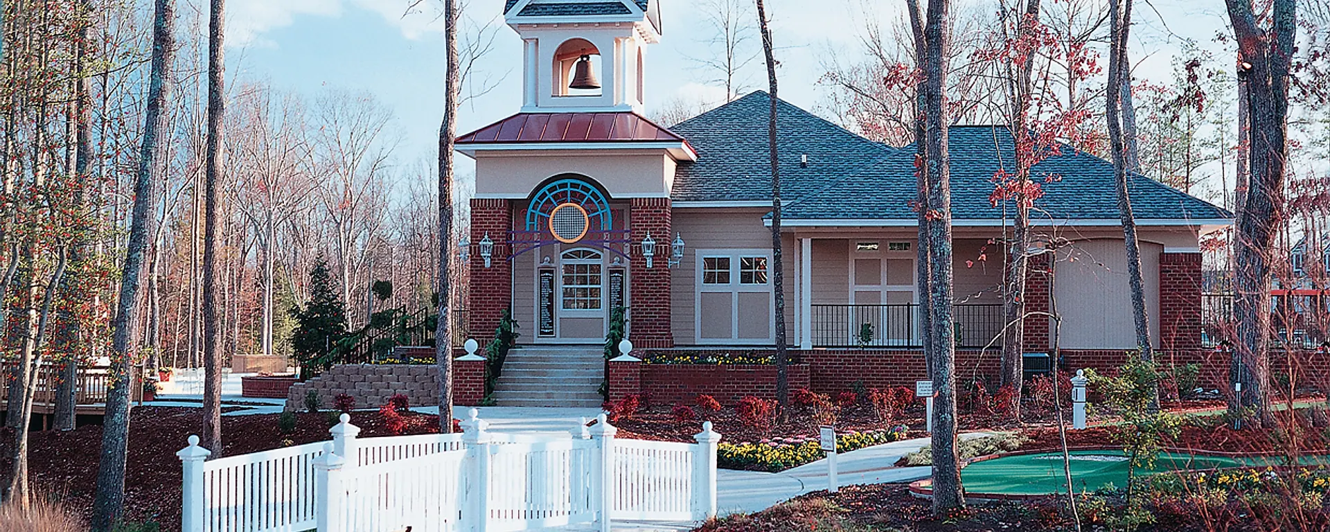 The Hampton Park residents' club, bell tower, bridge, and landscaped grounds