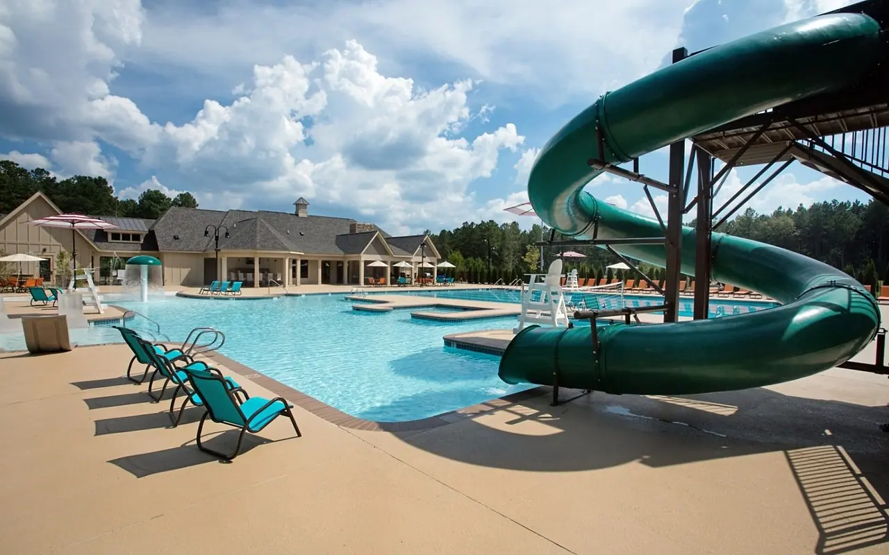 The Harpers Mill pool, waterslide, clubhouse, and wooded setting