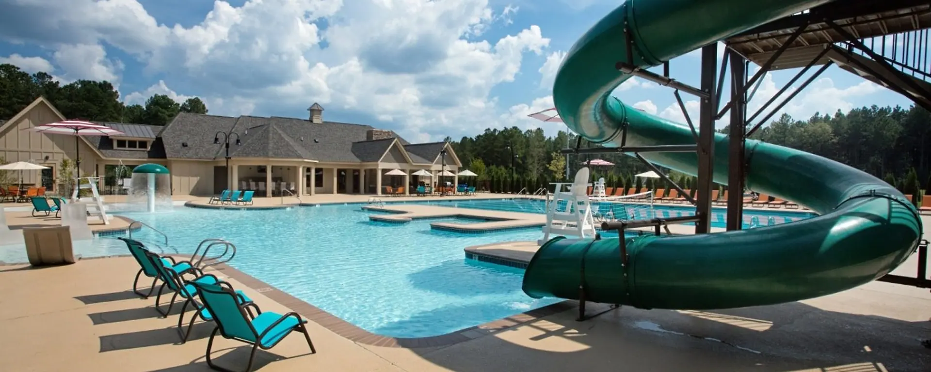 The Harpers Mill pool, waterslide, clubhouse, and wooded setting