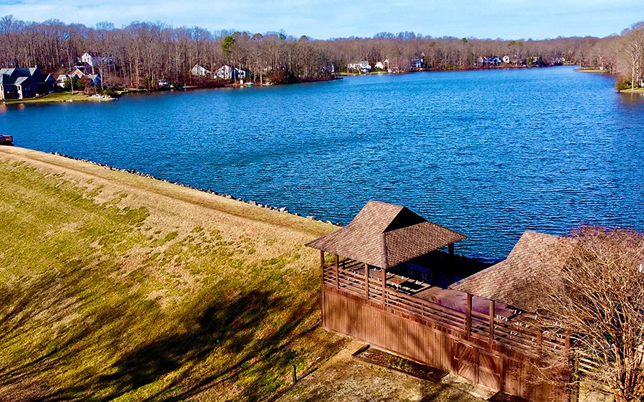 Aerial view across Lake Salisbury, shoreline homes, and the lakeside pavilion