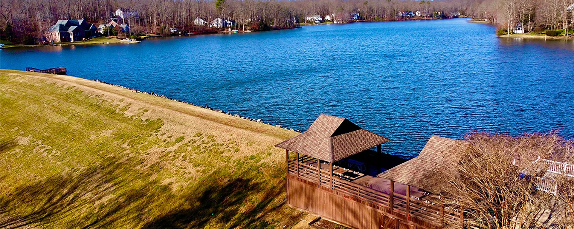 Aerial view across Lake Salisbury, shoreline homes, and the lakeside pavilion