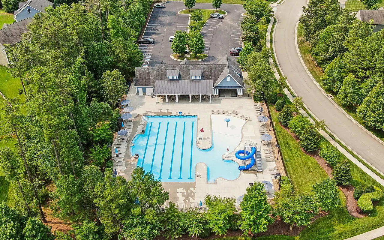 Aerial view of the Westerleigh clubhouse, pool, streets, and surrounding trees