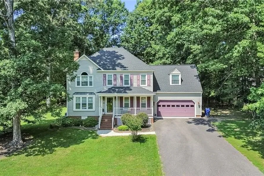 Front exterior of 1424 Laurel Top Drive, a brick and siding home with dormer windows