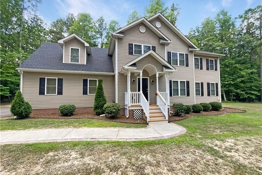 Front exterior of 17430 Simmons Branch Terrace, a two storey home on a wooded lot